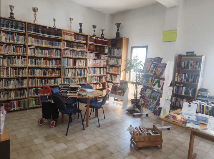 Interior da Biblioteca — estantes de livros e espaço infantojuvenil